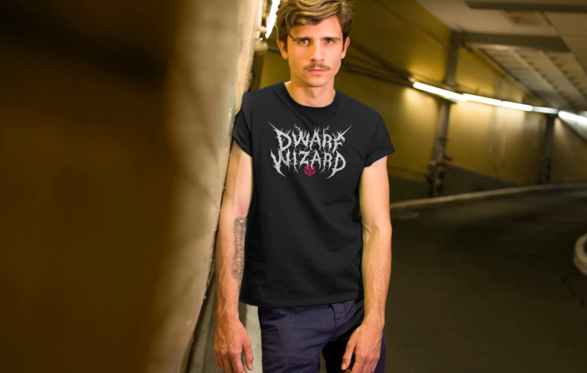 Hip guy modeling a black graphic t-shirt with white Dwarf Wizard with in metal band typography